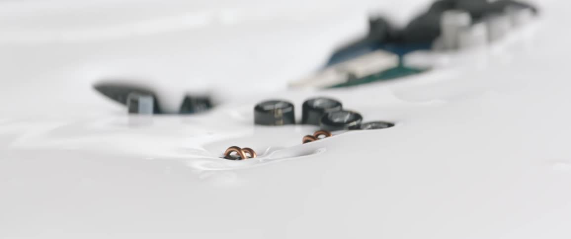 Metal objects sinking in to white liquid