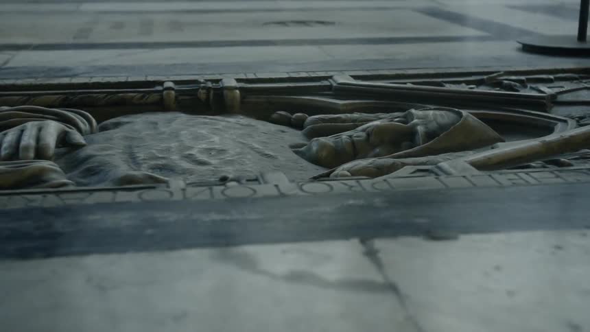 Carving of a man laying in a tomb