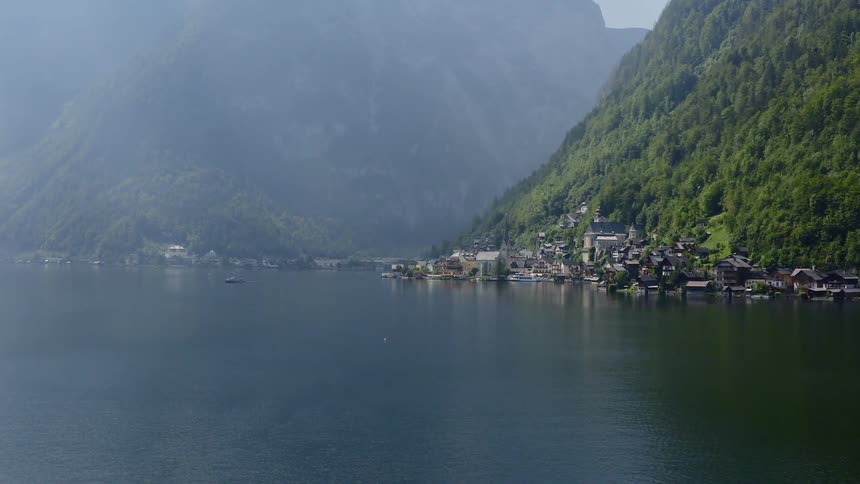 The coast is lined with houses near the mountain