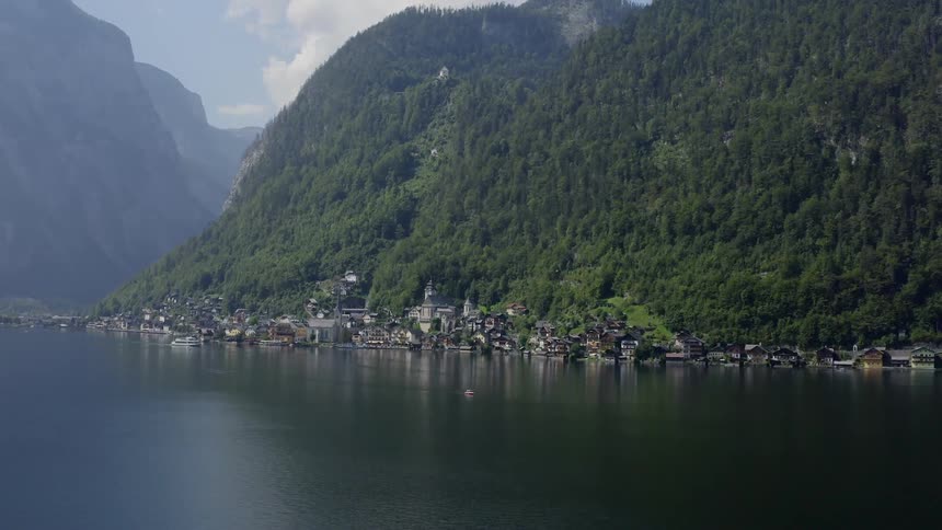 Houses along the shoreline with hills behind
