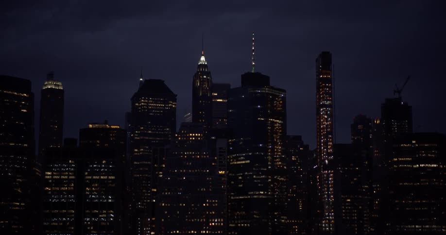 Window lights in a city skyline glow in skyscrapers at night