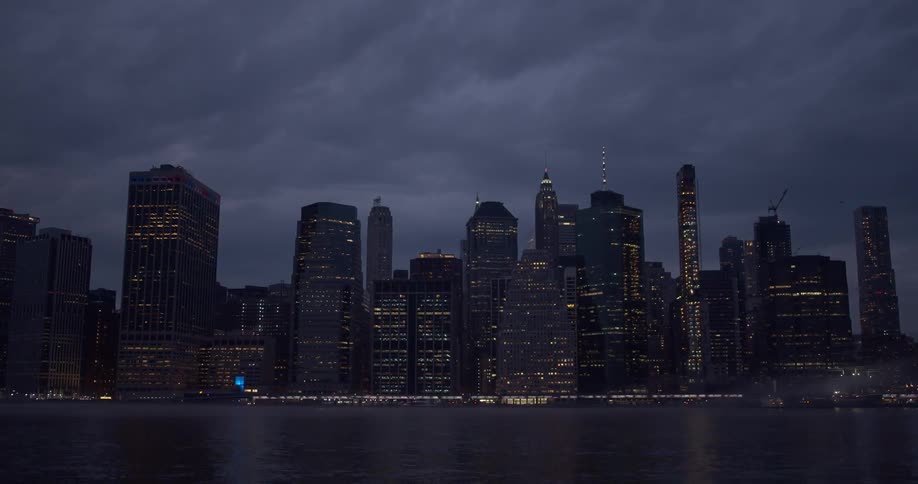 Clouds move over a city at night