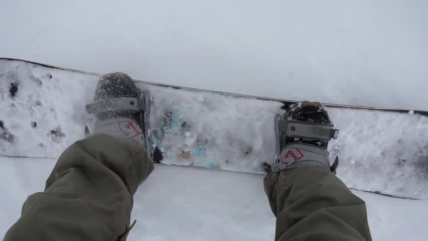 A snowboarder slides down a mountain