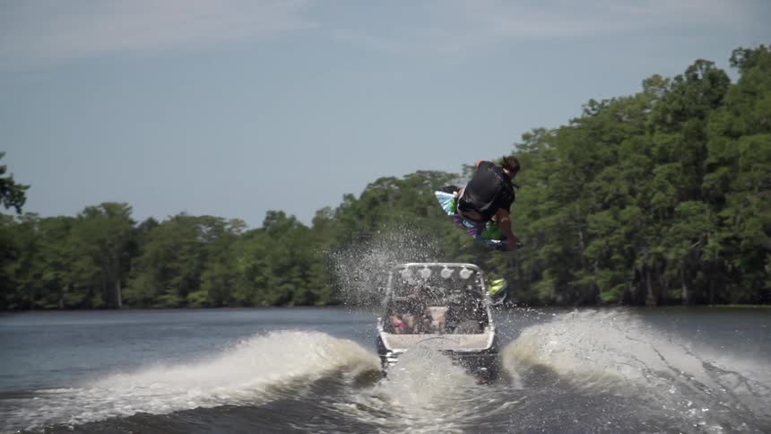 A man wakeboarding behind a boat