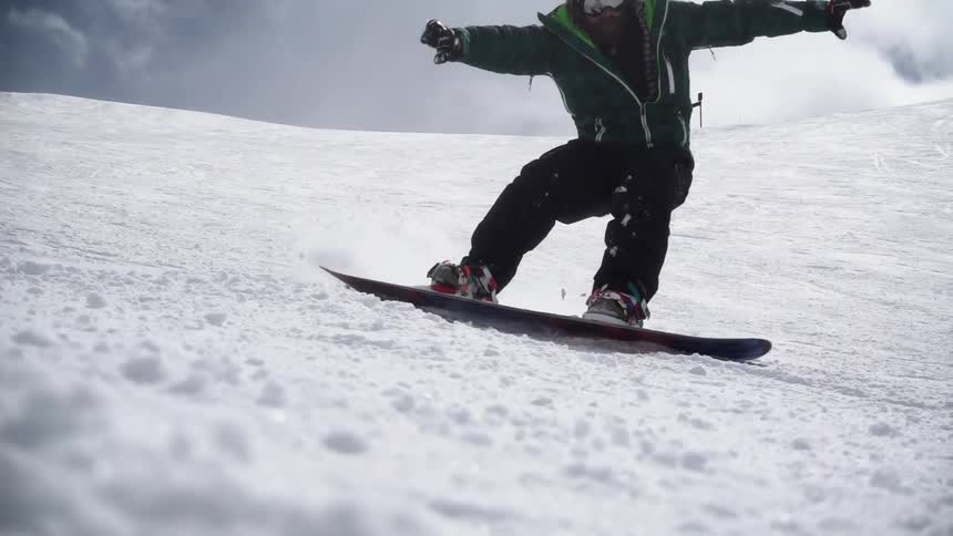 A person is snowboarding down a steep hill