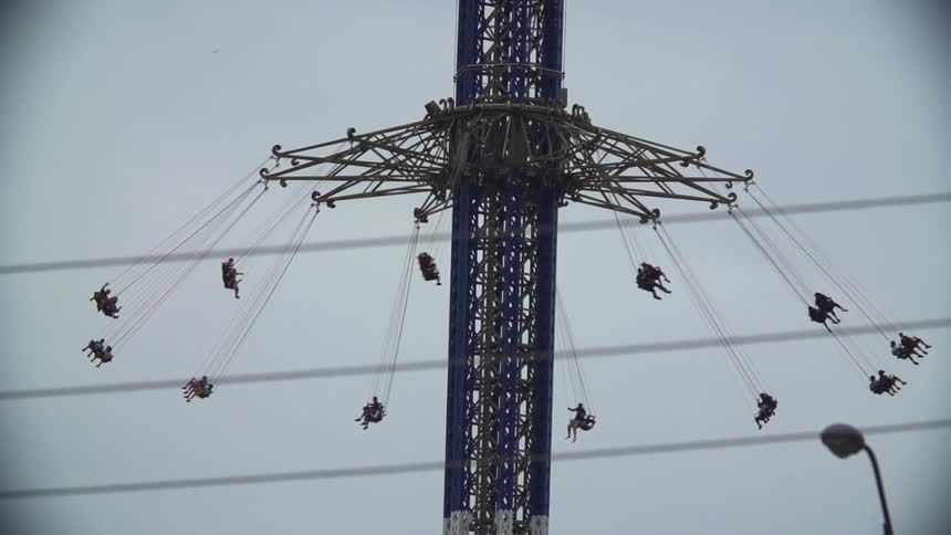A carnival ride rotates in slow motion