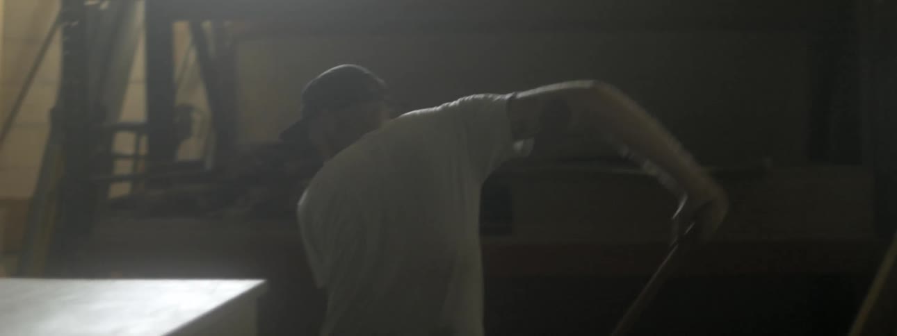 Man mopping the floor in a warehouse