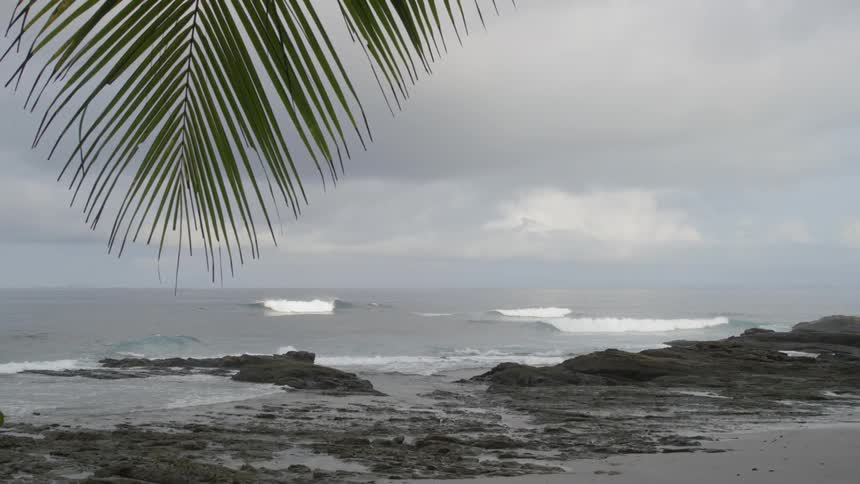Waves roll in towards a rocky shoreline