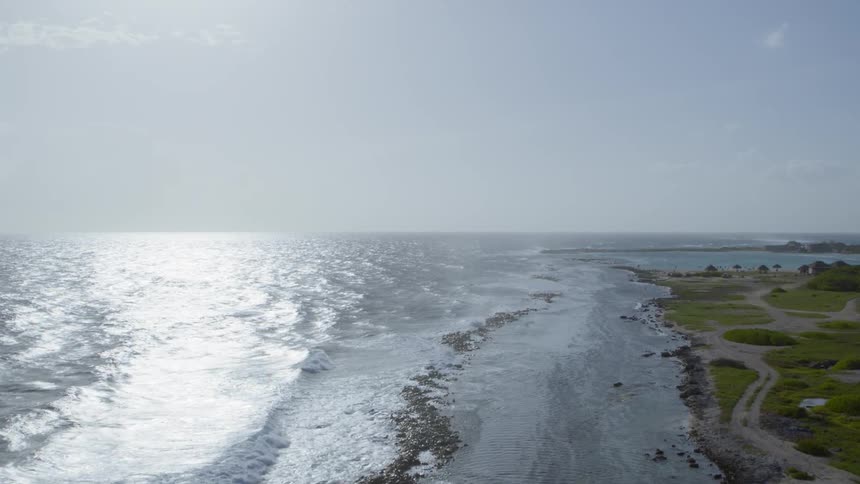 Sparkling surf rolling into gently sloping coastline
