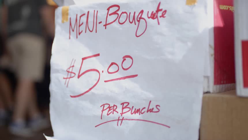 Close up of a sign selling baguette in public market