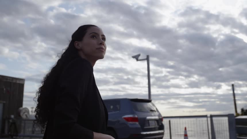 A woman walks in the car park