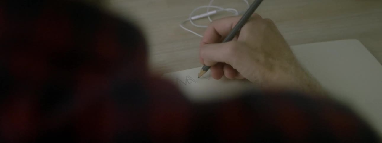 Man writes in a notebook