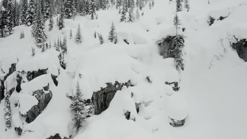 A person is snowboarding down a mountain