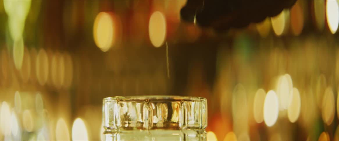 Ice placed into a glass using tongs