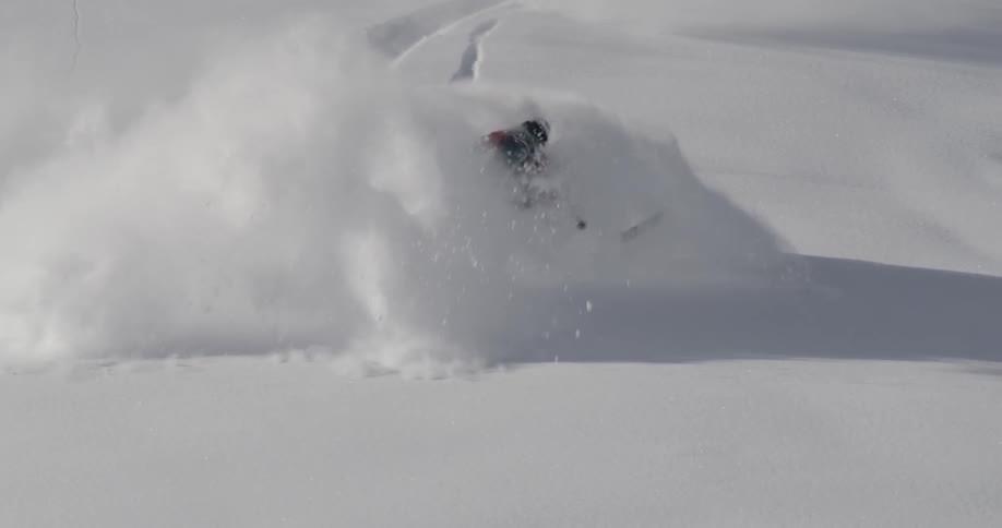 A man playing ski in the middle of mountain snow
