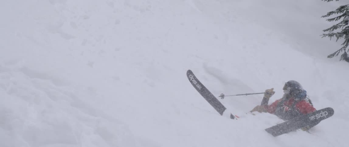 A skier is stuck in the snow during a blizzard