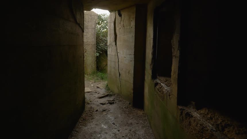 Old cement is cracked inside an abandoned building
