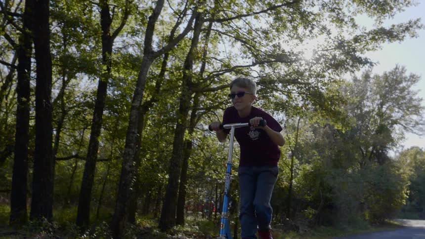 A boy playing scooter