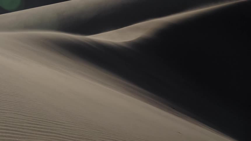 Sand dunes in a desert during the day
