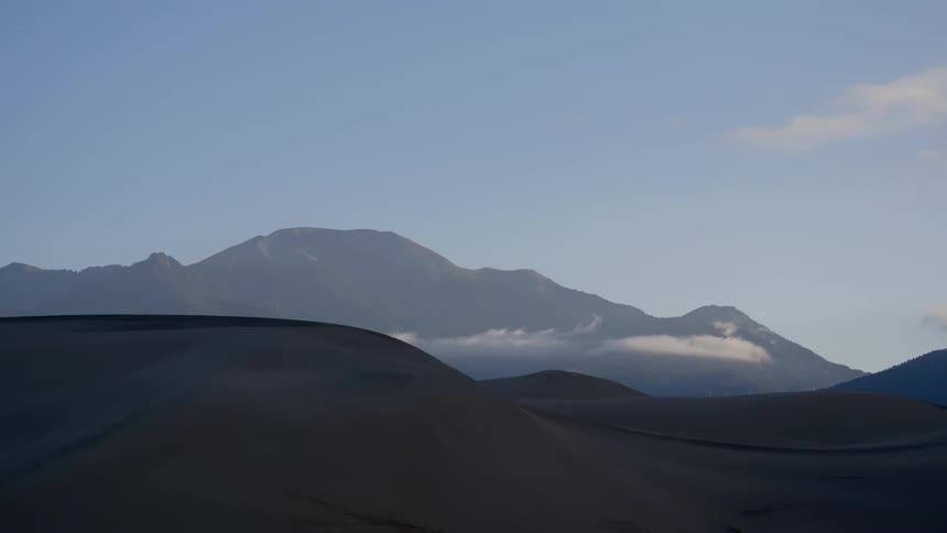 Sand dunes under a blue sky