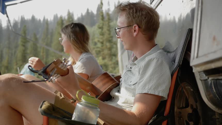 A blonde couple enjoying their camping