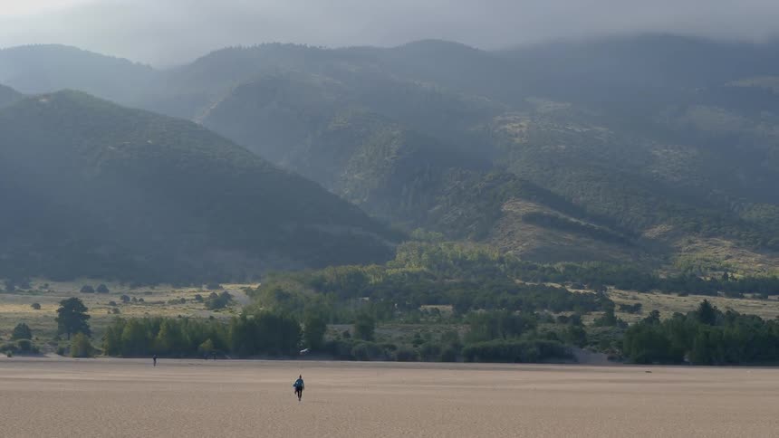 People walk across an open field