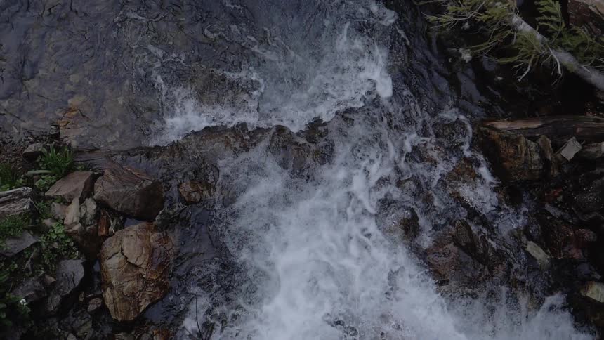 A river rushes across rocks and boulders on the river bed