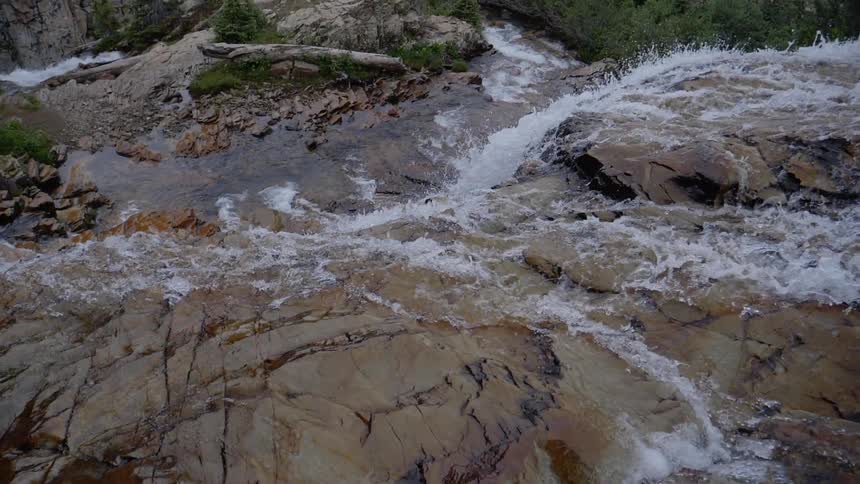 Water rushes down and over rocks