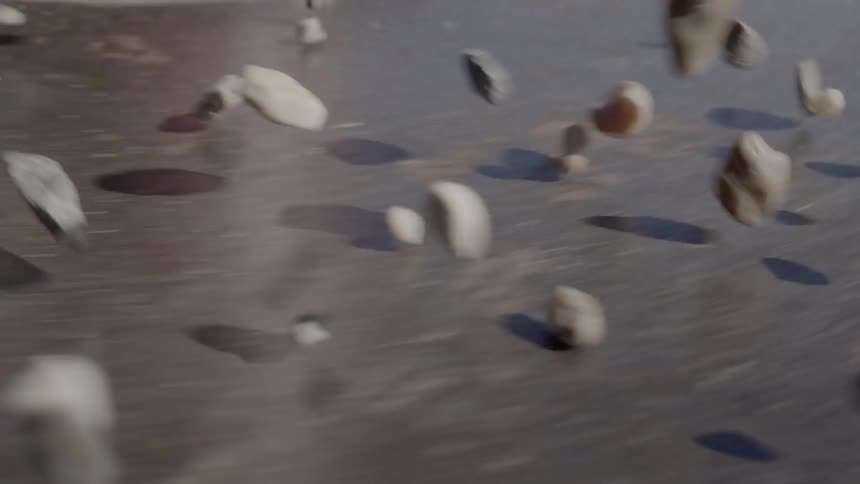 Rocks and pebbles rolling on a flat surface
