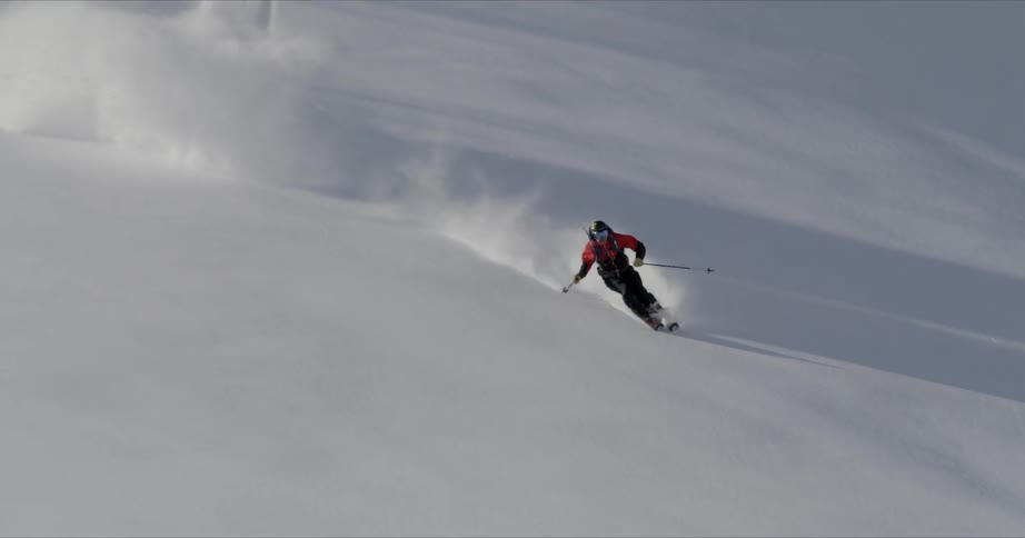 A person skis quickly down the mountain