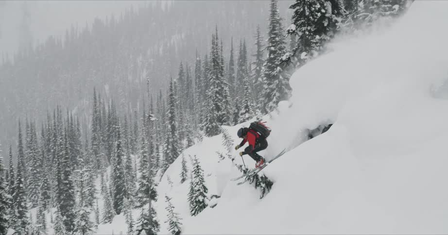 A man doing a down hill with a snowboard