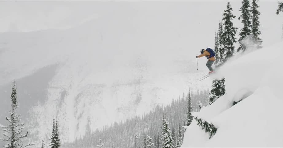 A man doing a down hill with a snow board