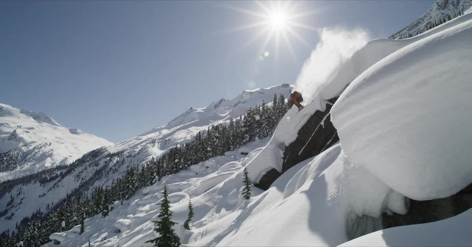 A person jumps off the cliff on his skis