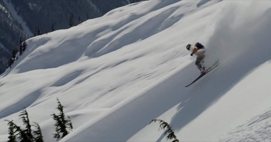 A man is skiing down a mountain during winter
