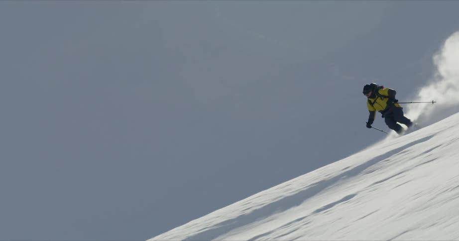A man is skiing down a mountain during winter