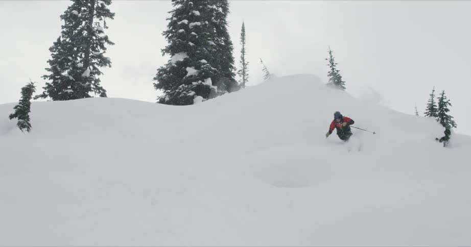 A person skis down the mountain