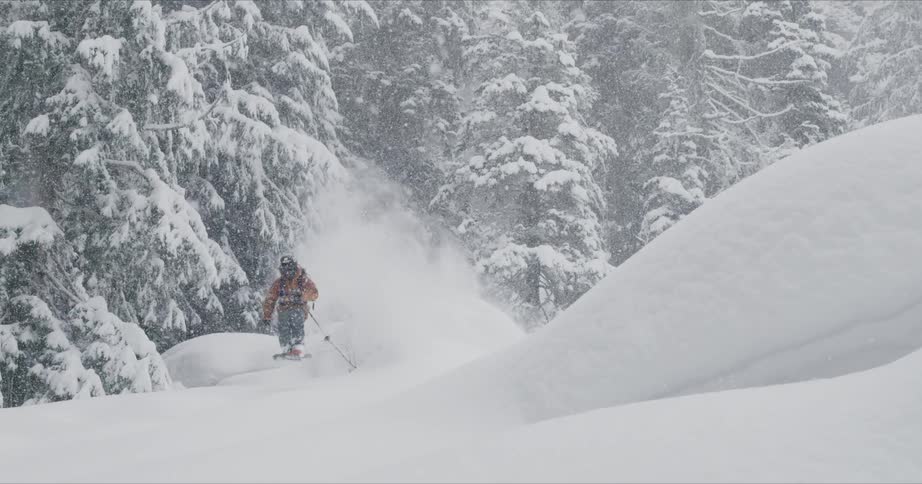 A skier jumps traveling down the slope