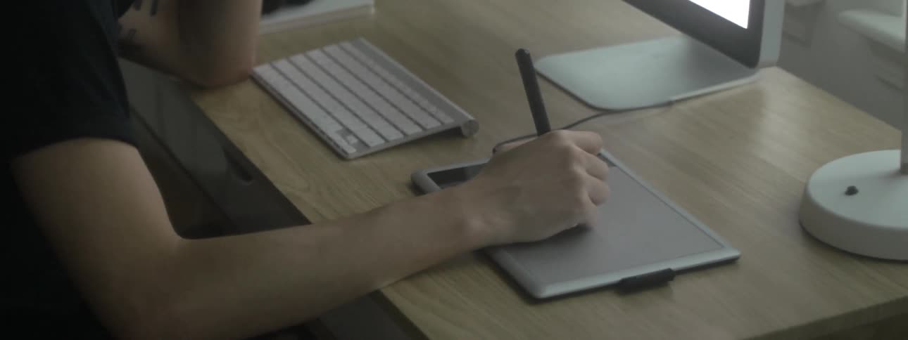 A man writing on a digital pad