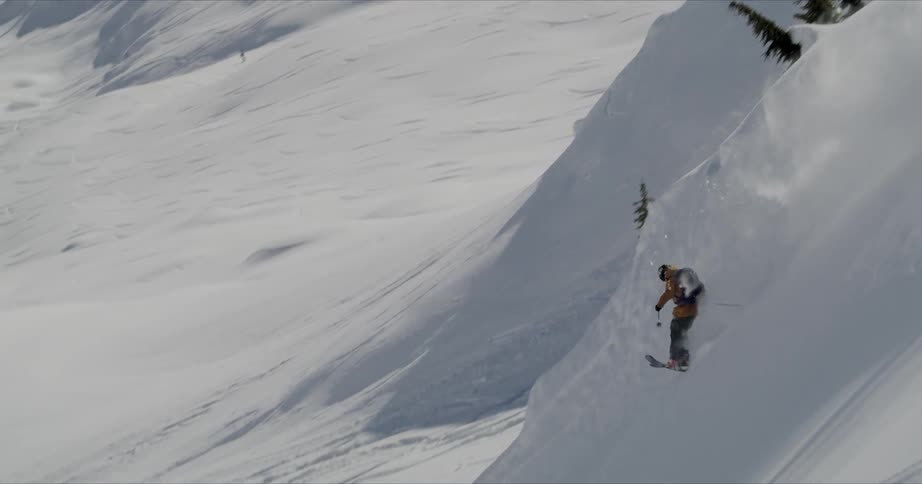 A skier goes down a snow covered mountain