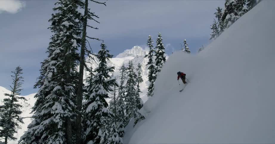 A person is skiing down a mountain during winter
