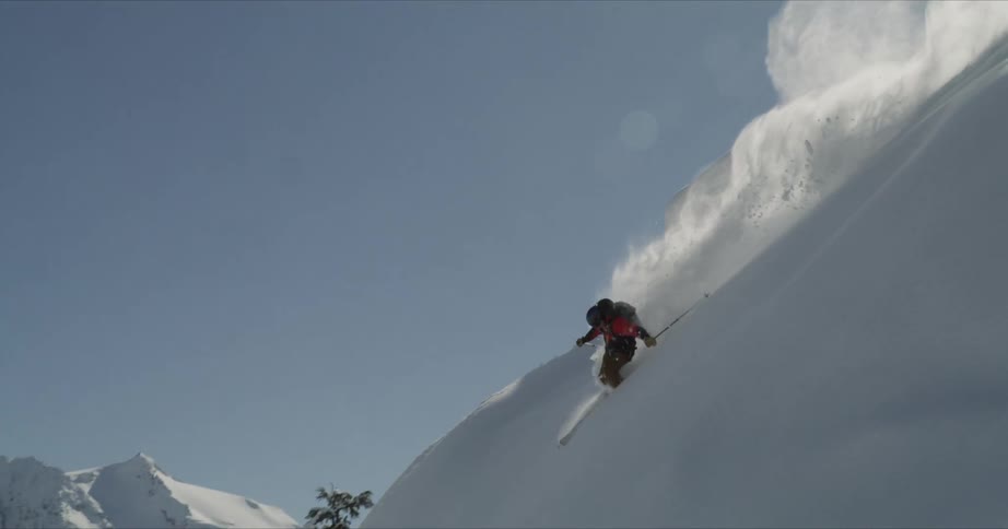 A person is skiing down a mountain during winter