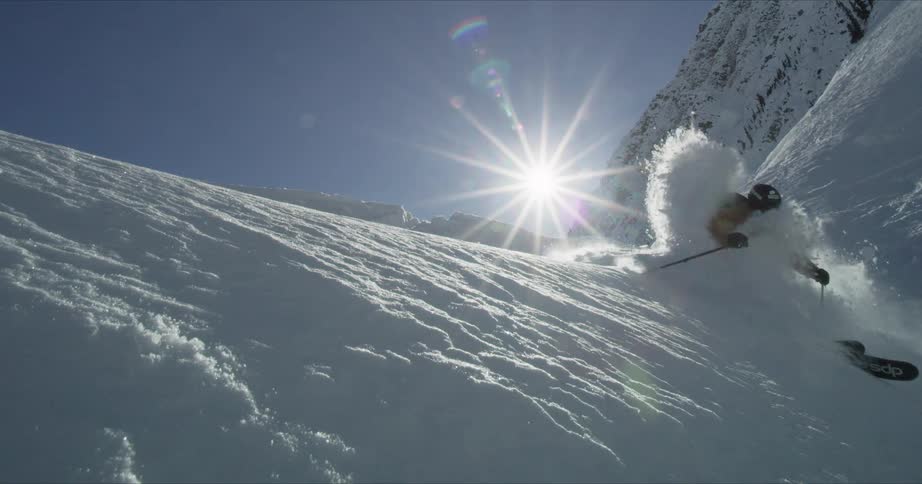 A skier carves deep powder