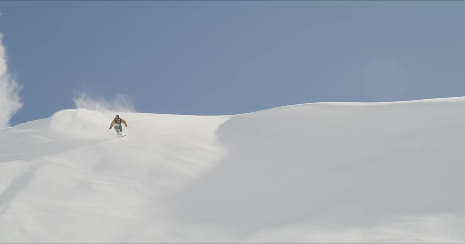A person skiing down a snowy slope