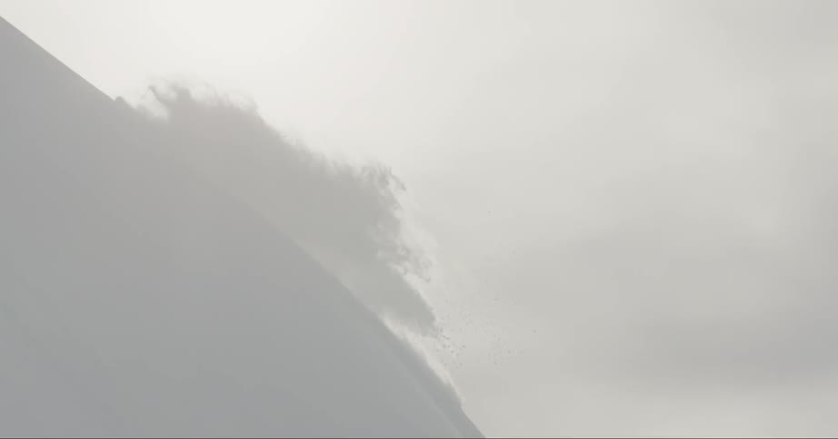 A skier tumbles going down a slope
