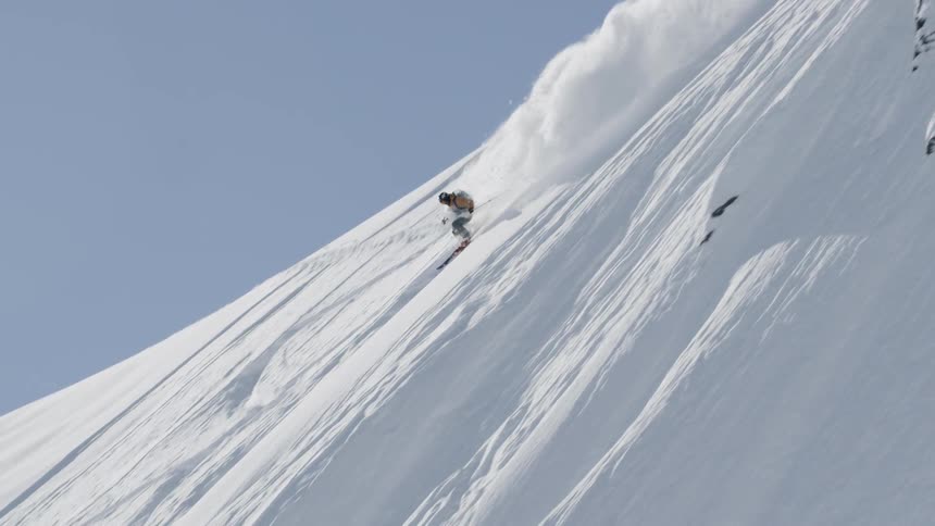 A person skis down the mountain