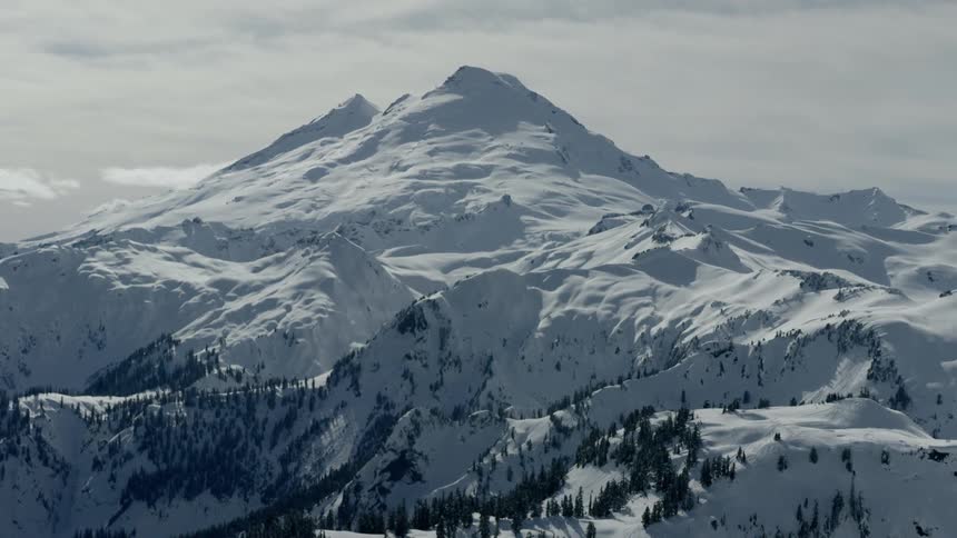 A mountain covered in snow during the day