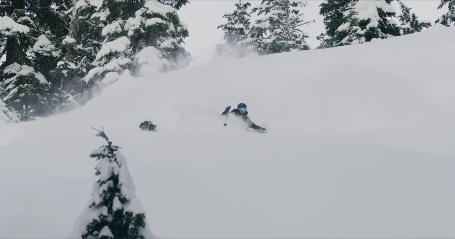 A person skis down a mountain side
