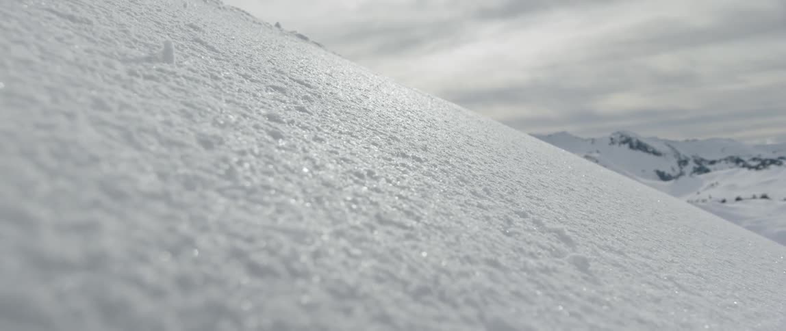 Ice crystals sparkle on the side of a snowy mountain