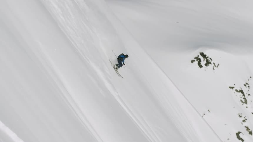 A man doing downhill with a snow board
