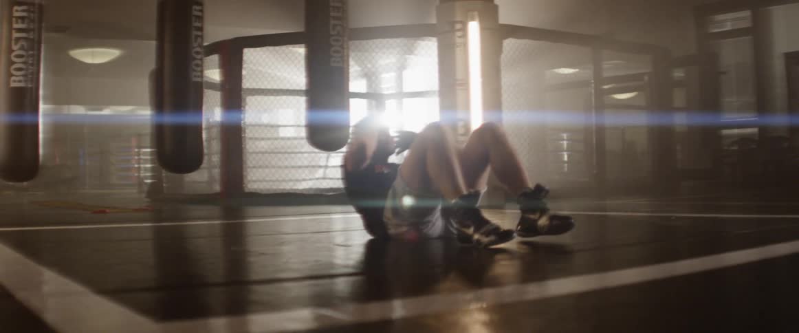 Boxer does sit ups in the gym